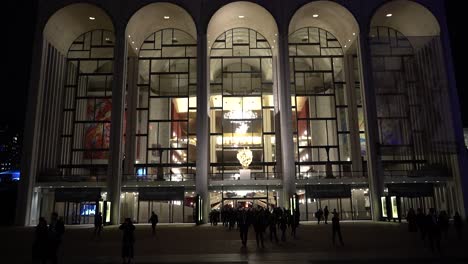 people coming out of the metropolitan opera house at night in new york city nyc