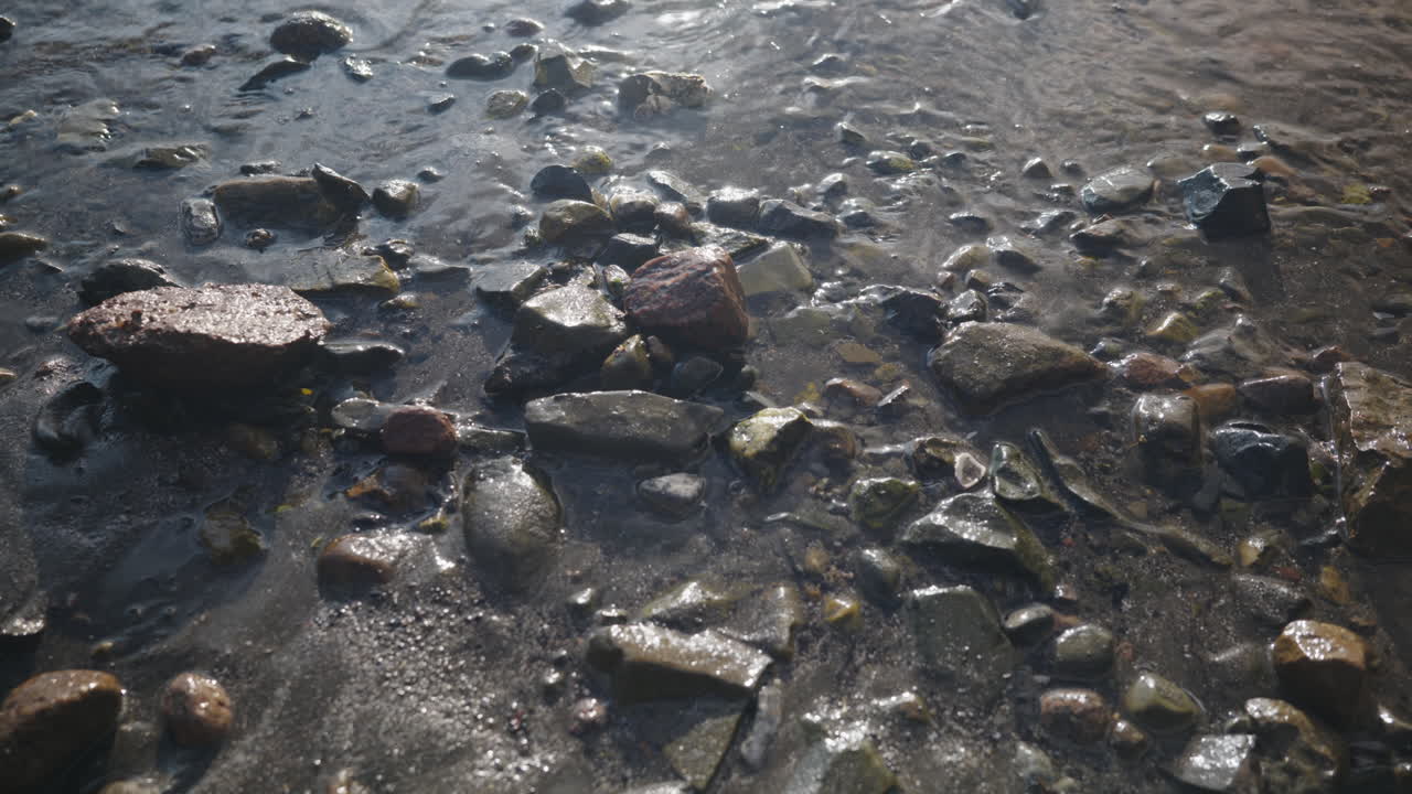 Small waves comes calmly into the beach on a sunny day