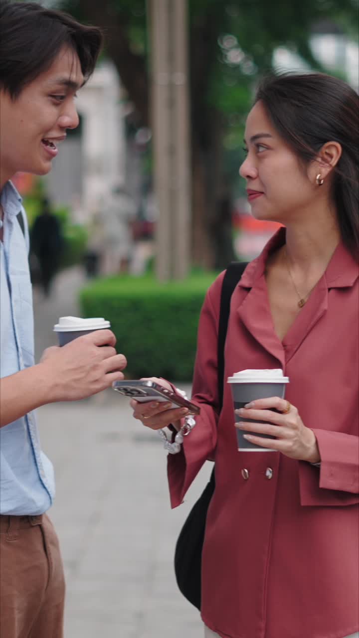 Two young adults looking at a smartphone