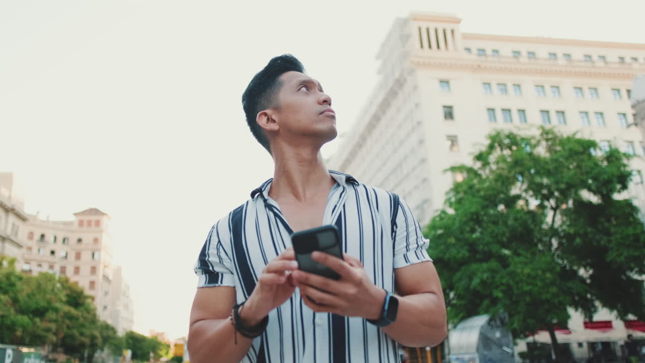 Man on City Street Using Smartphone