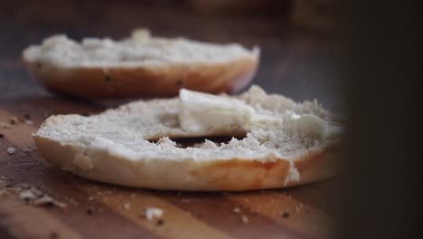 spreading cream cheese on a bagel