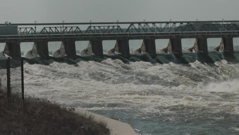 late flood waters of the ottawa river rushing through the levee of the hydro electric dam at chaudière island in ottawa, ontario