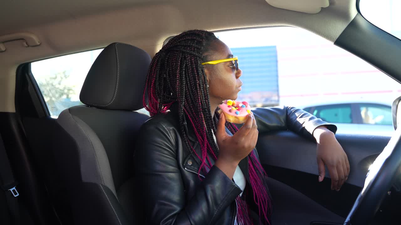 Woman Eating Donut in Car