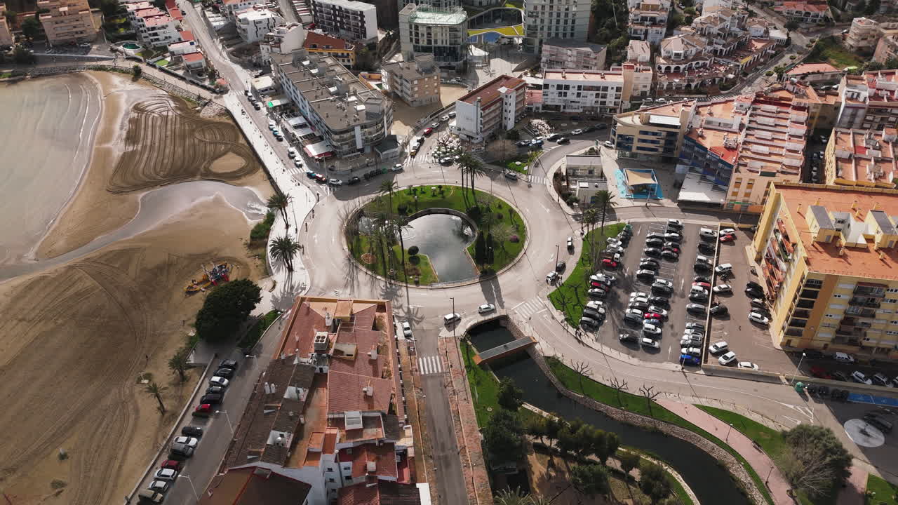 Aerial over Plaça Constituciò roundabout in Peniscola with ocean and road in establishing