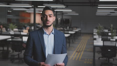 professional businessman holding documents in an office