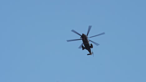 military helicopter flying up above under clear sky