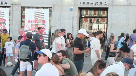 busy street scene outside sephora store with sales signs