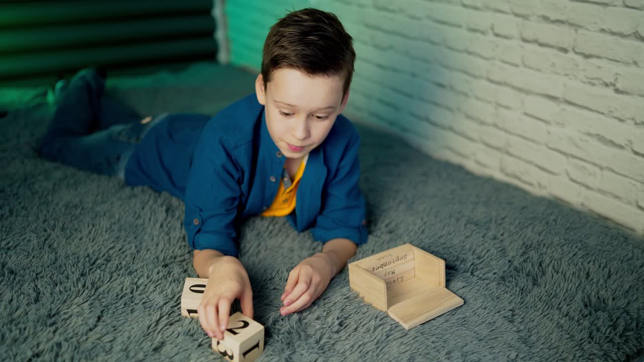 boy play with wooden block calendar.
