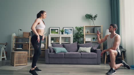 couple exercising at home, video recording
