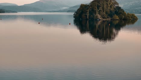 serene lake with island reflection at sunset