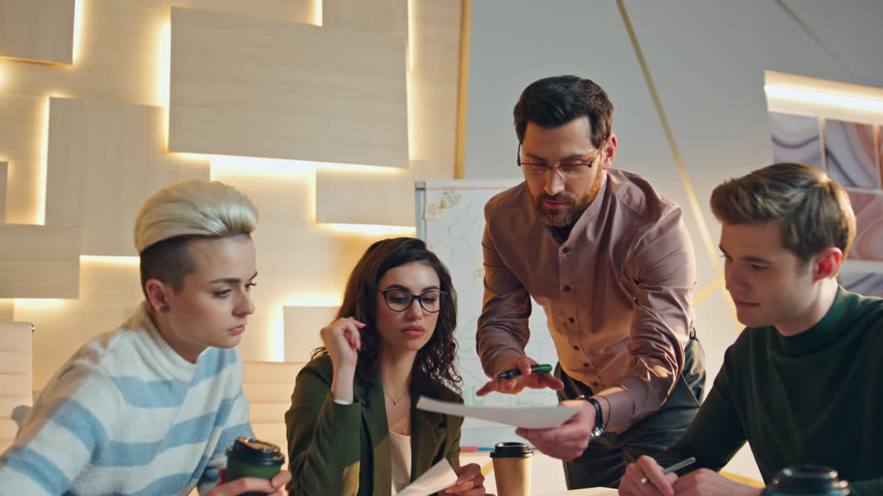 Office coworkers analysing business project in boardroom. Manager presenting