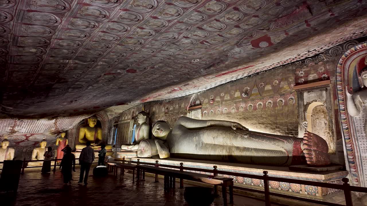 Detailed view of ancient artworks on the ceiling of Dambulla Cave Temple, showcasing vibrant cultural and religious heritage in Sri Lanka.