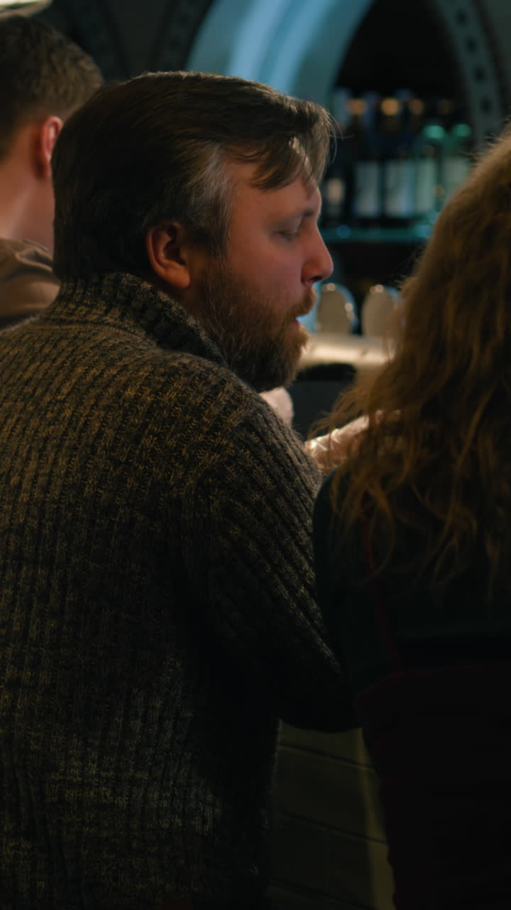 Man in a Sweater at an Indoor Bar or Pub