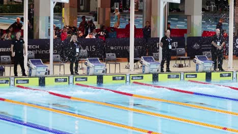 swimmers compete in a pool race event