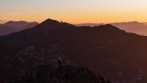 aerial drone shot capturing the golden sunrise over the misty mountain ranges of nainital.