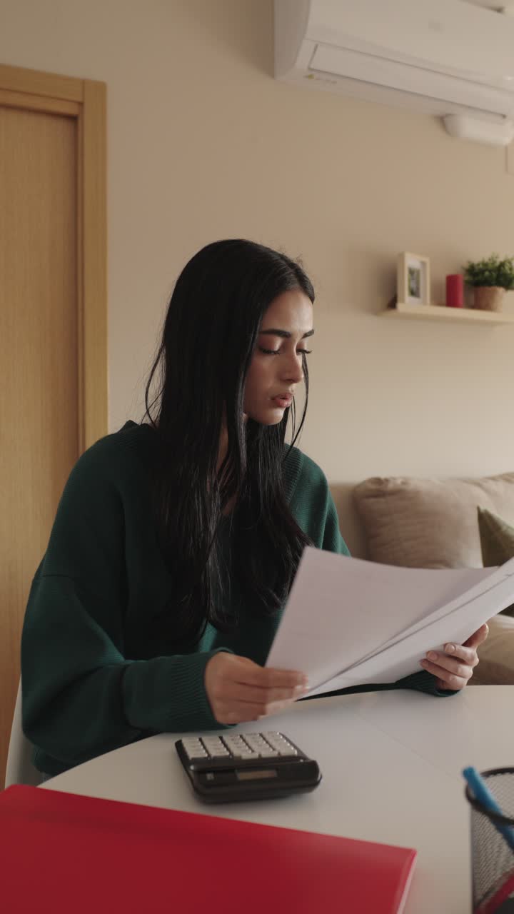 Woman reviewing documents at home
