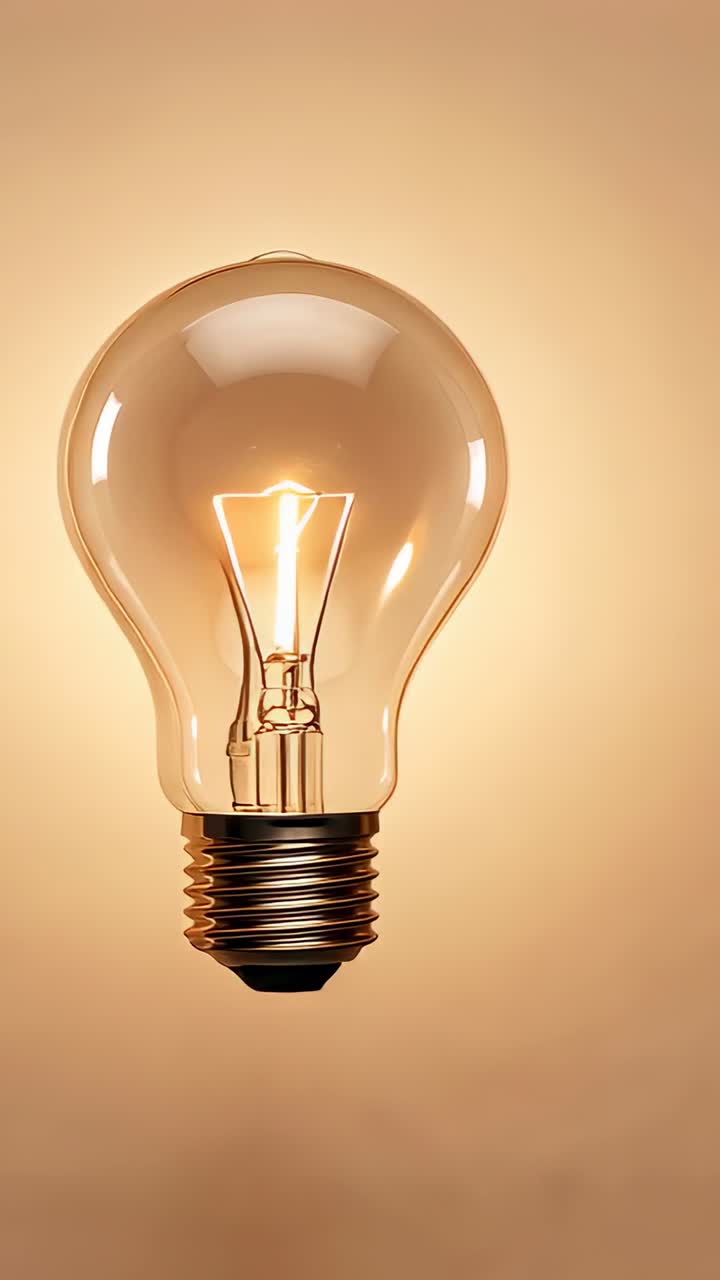 Vertical video: Incandescent filament bulb glowing brightly upon switch flip in studio with cord