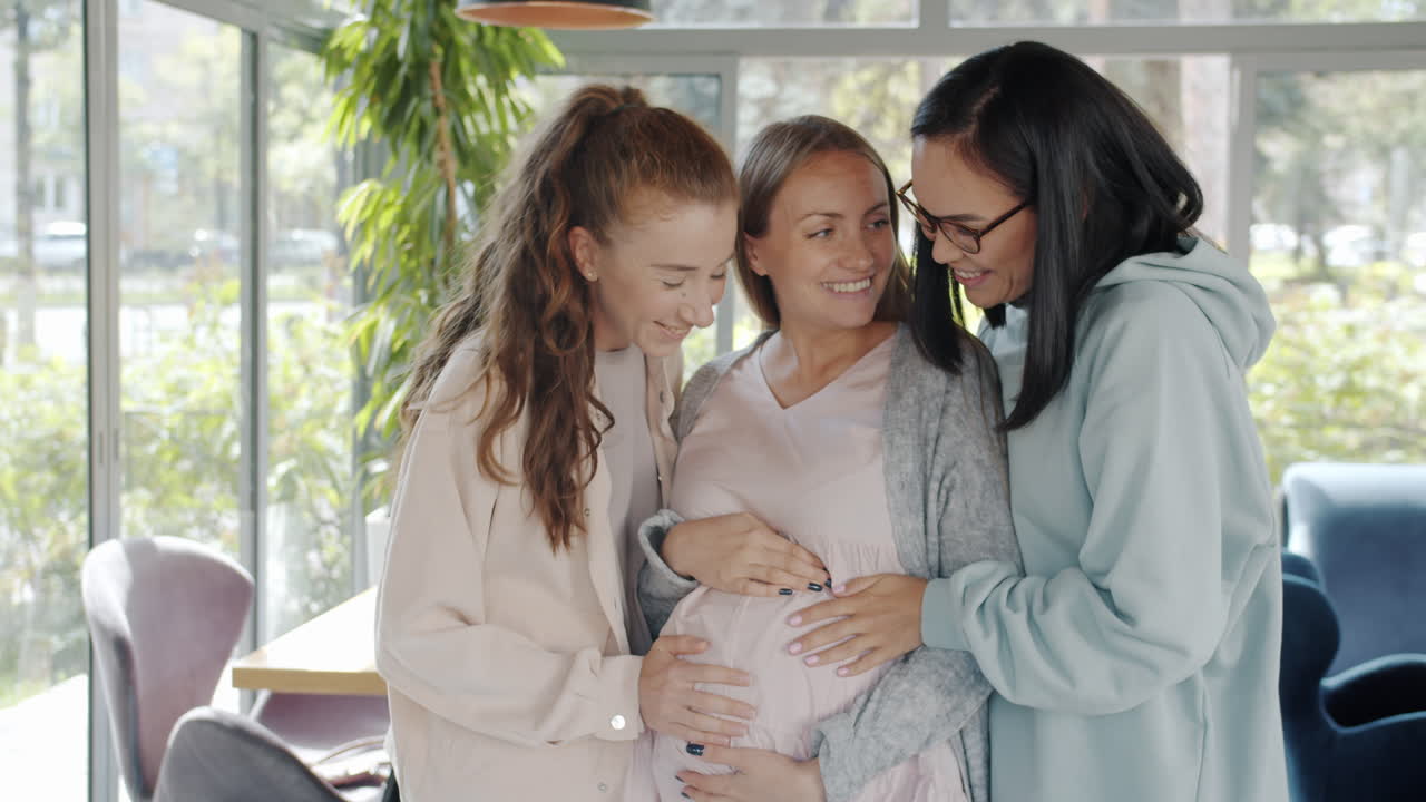 Friends Supporting a Pregnant Woman