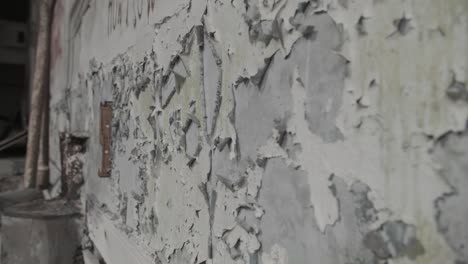 grungy flaking paint on abandoned building wall