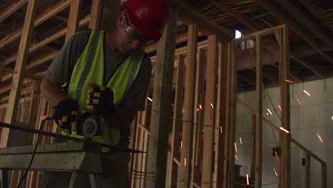 construction worker grinding metal and making sparks