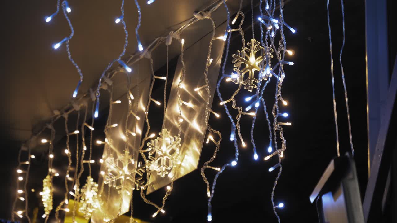 Fairy Lighting And Snow Flake Decorations Hanging Indoors