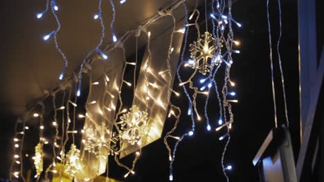 fairy lighting and snow flake decorations hanging indoors