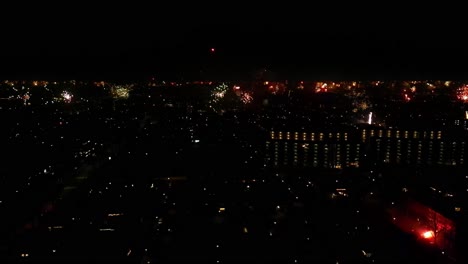 Panoramic-View-Over-Cityscape-Illuminated-With-Beautiful-Fireworks-During-Nighttime