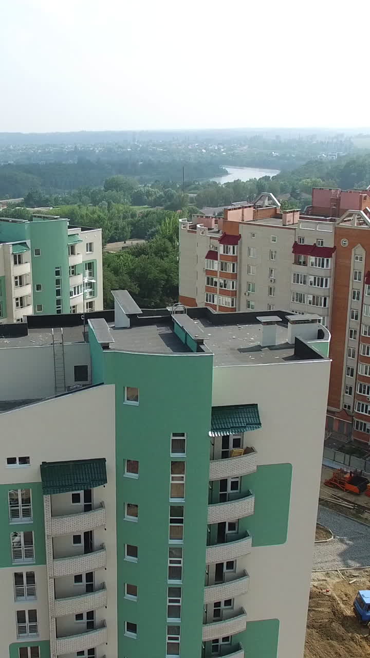 Panoramic view of modern residential complex in the city. Modern design of a multy-storeyed buildings in a new construction area. Aerial view Vertical video
