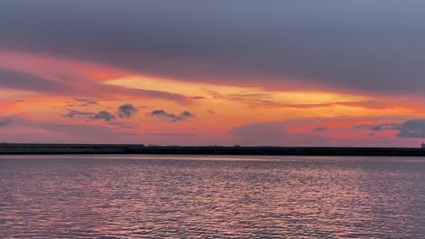 Sunset-in-marina-dock-over-water-reflection