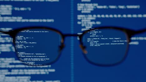Coding on blue screen computer system thru eye glasses insight vision in data scientist programming ai for machine learning operation, modeling predictive analytics, data engineering IT skill concept.