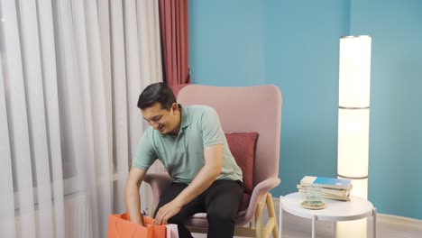 Man-looking-at-camera-with-shopping-bags.