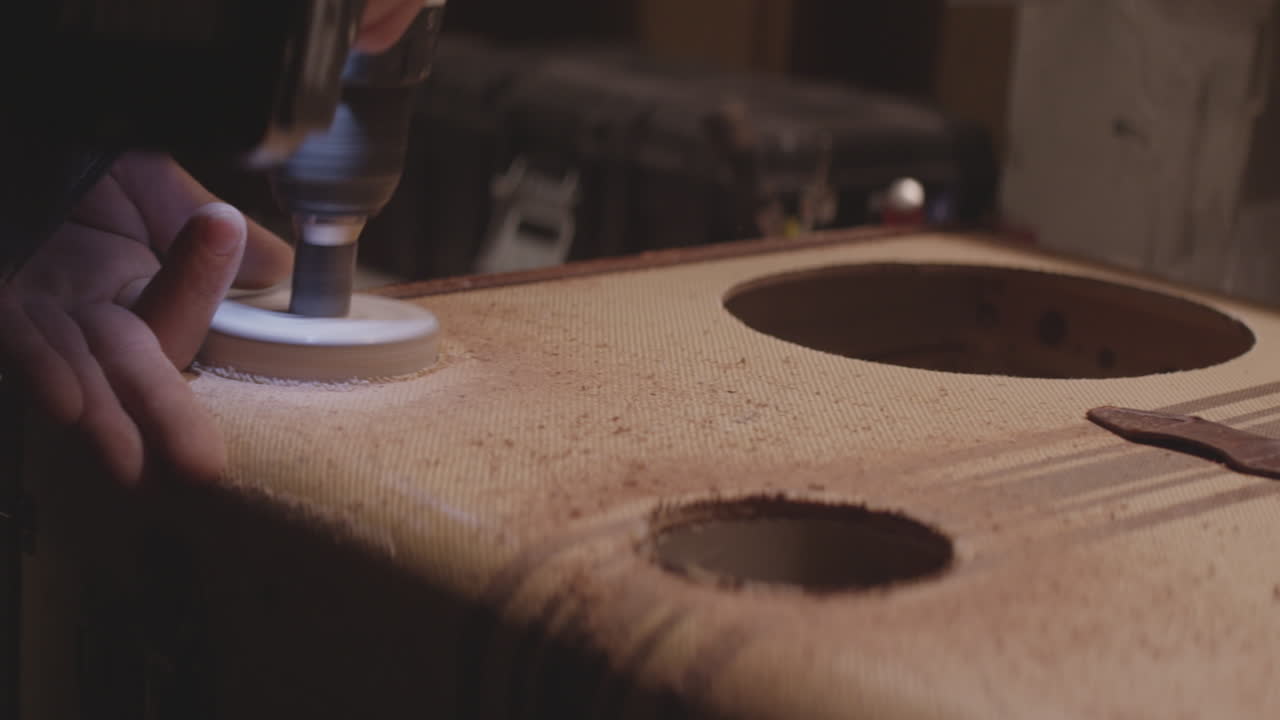 A person drills holes into a suitcase