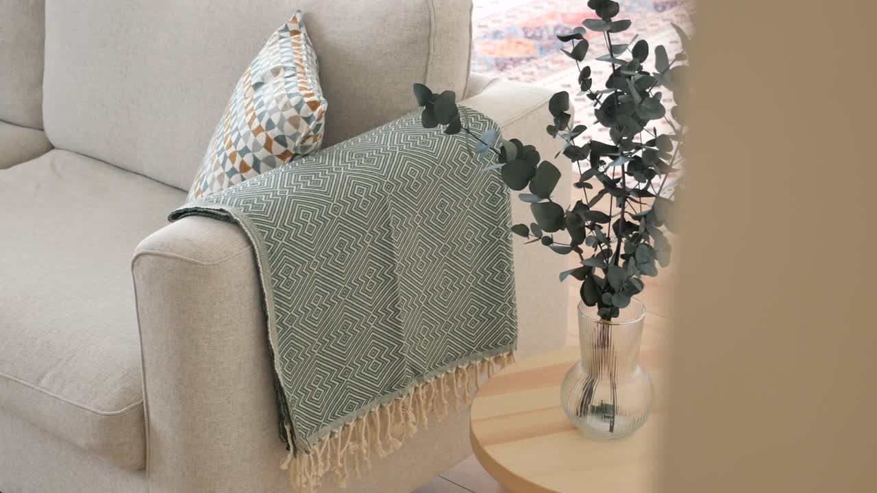 Stylish Living Room with Grey Sofa, Pillows, and Throw Blanket