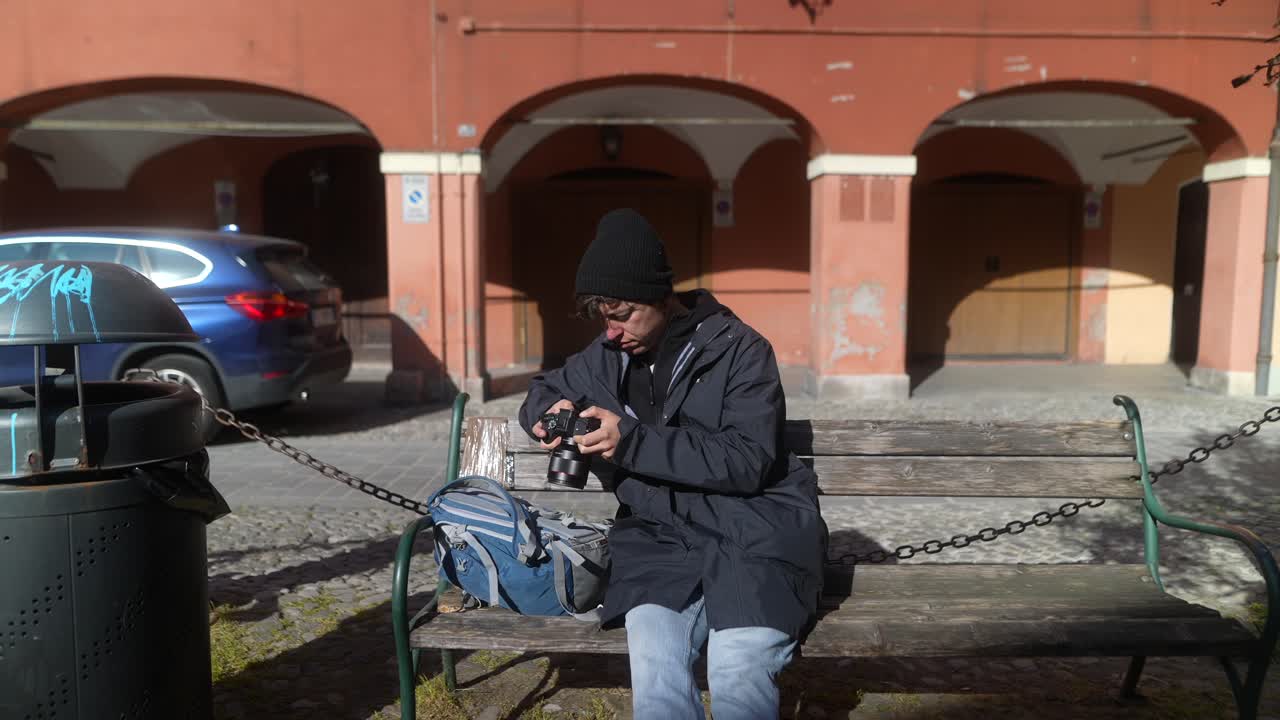 Teenager taking photos on a bench in a European city