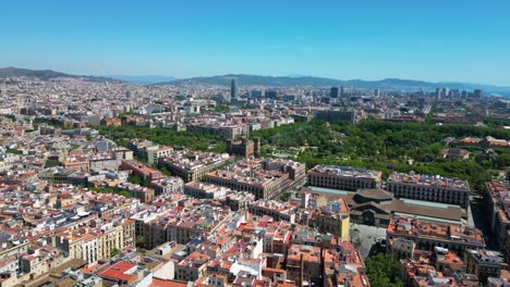 barcelona skyline with public park ciutadella (parc de la ciutadella) and the city centre all around and torre glories and big hills in the background in barcelona, catalonia, spain