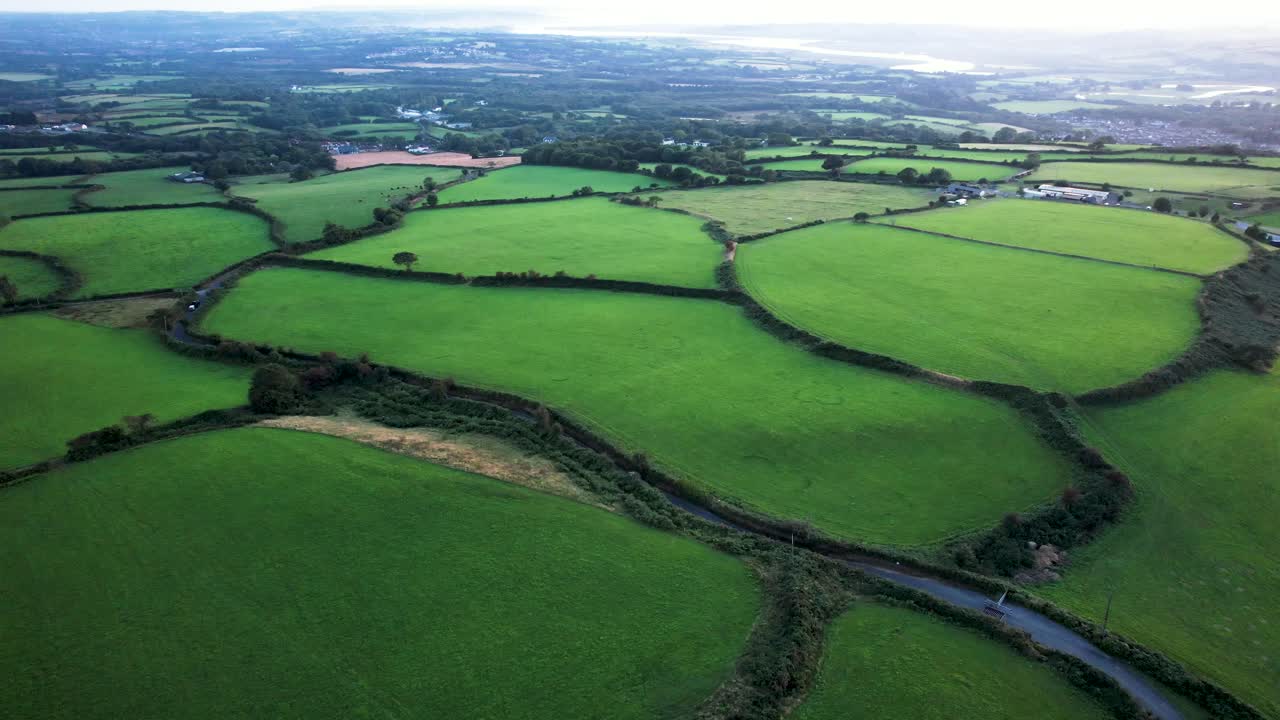 AERIAL: Fly across lush green farmer's fields, Gower, 4k Drone