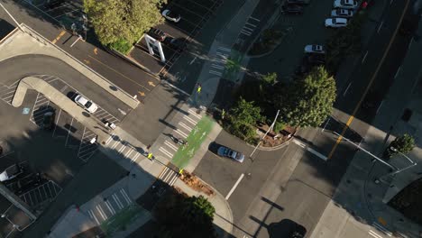 Aerial-view-of-bikes-riding-safely-on-a-designated-bike-lane-while-a-car-waits-for-them-to-pass-before-proceeding