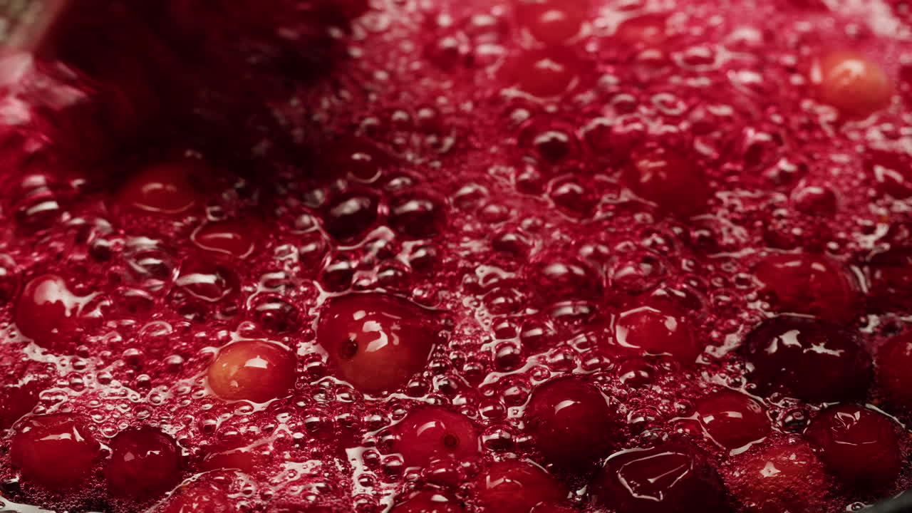 Frozen cranberries cooking for tea or jam, Background Close up of cranberry berries in on the kitchen, chef making dessert healthy pie.