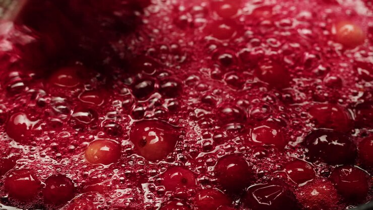 Frozen cranberries cooking for tea or jam, Background Close up of cranberry berries in on the kitchen, chef making dessert healthy pie.