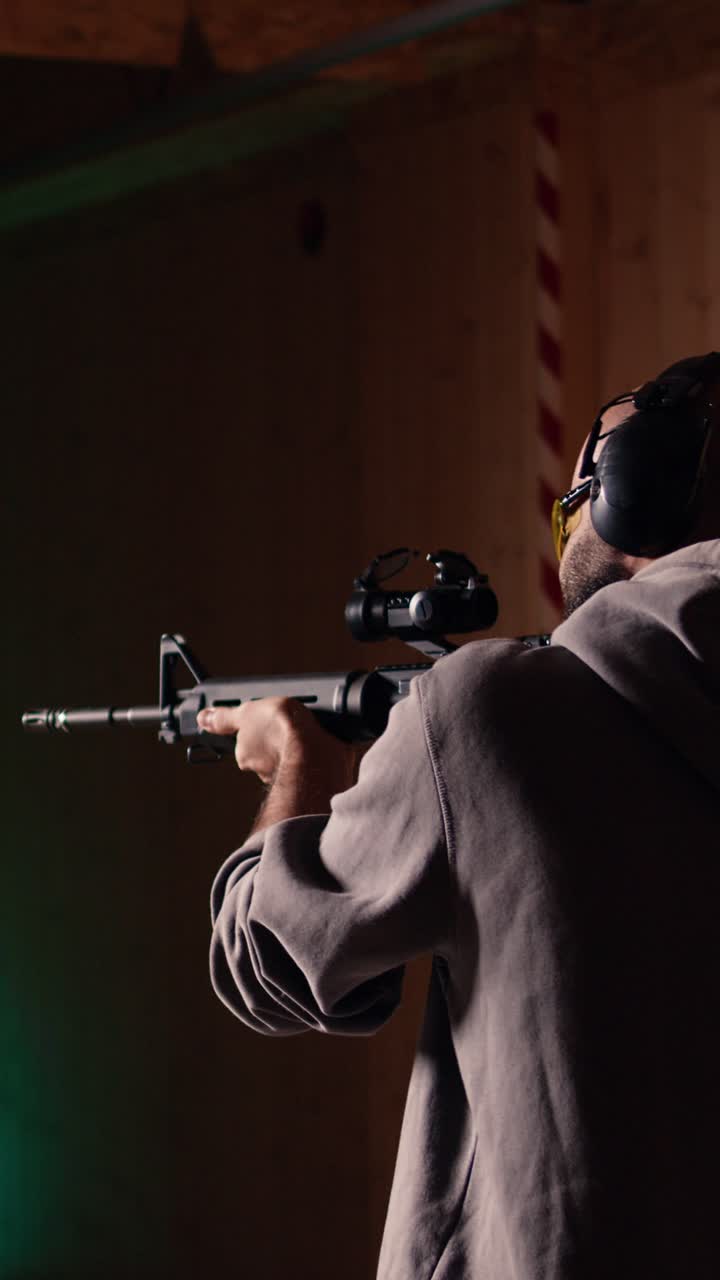 Vertical video Shooting range customer shooting targets with semiautomatic weapon