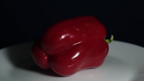 Red-Bell-Pepper-spinning-around-on-a-white-plate-revealing-this-healthy-food