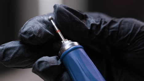 Close-up of tools in black gloves