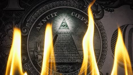 pyramid on a banknote of 1 us dollars bill with glowing freemasons eye on top on fire in flames. conceptual 4k slow motion raw video. financial crisis idea, conspiracy theory.