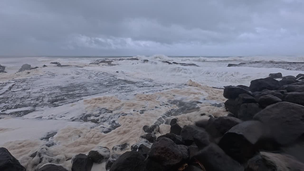 People With Umbrella At Snapper Rocks Amidst Cyclone Alfred And Strong Waves In Gold Coast, Queensland. panning shot