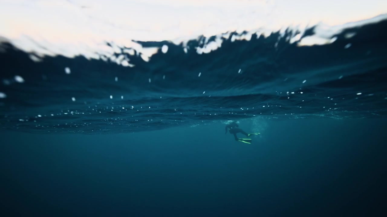 Waves rolling above Arctic Norway fjord with faint shadows underwater