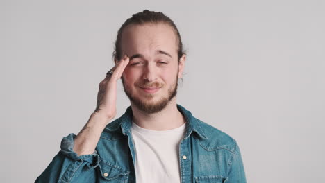 caucasian young man showing headache.