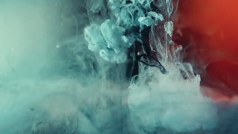 slow motion of falling blue colored nebula and red lights in background - explode magical ink effect