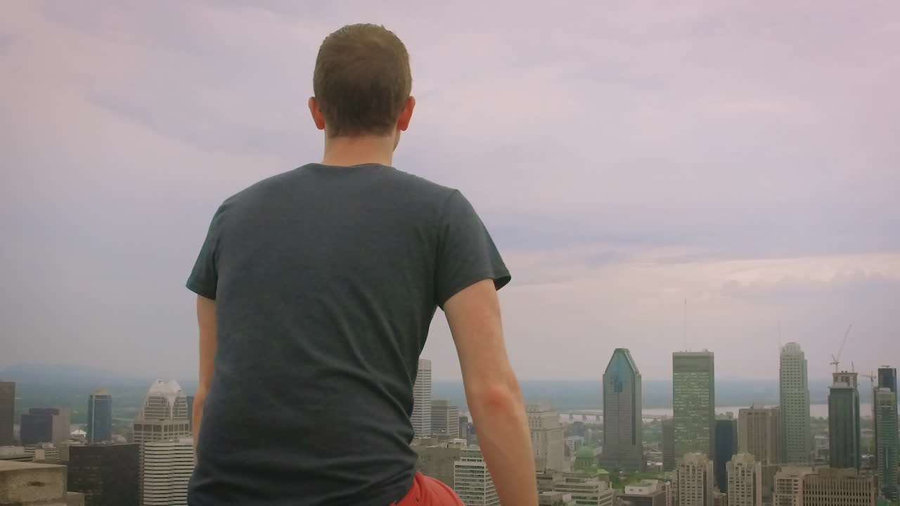 A red haired boy overlooking the metropolitan city