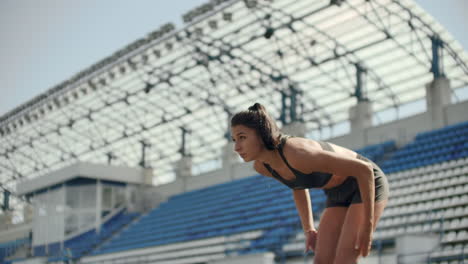 a time lapse portrait of beautiful woman running on the stadium bleachers with concentrated deep breathing and motivating myself and consciousness for the race. discard unnecessary emotions and tune in to win preparing for the race