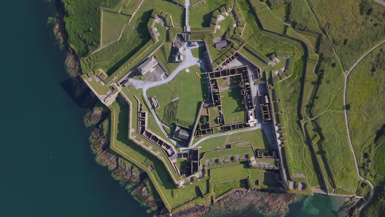 Aerial view of star-shaped Charles Fort on green coastline in Kinsale, Ireland